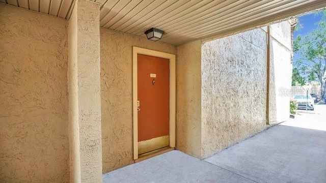 648 Kenwick Cir Unit 102, Casselberry, FL 32707 - view of exterior entry featuring stucco siding