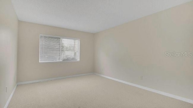 648 Kenwick Cir Unit 102, Casselberry, FL 32707 - carpeted spare room with baseboards