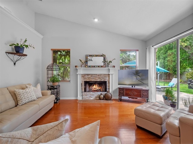 3518 Edlingham Ct, Belle Isle, FL 32812 - living area with vaulted ceiling, wood finished floors, and a fireplace