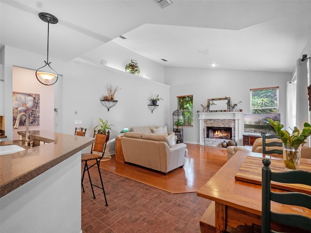 3518 Edlingham Ct, Belle Isle, FL 32812 - living area featuring plenty of natural light, vaulted ceiling, and a stone fireplace