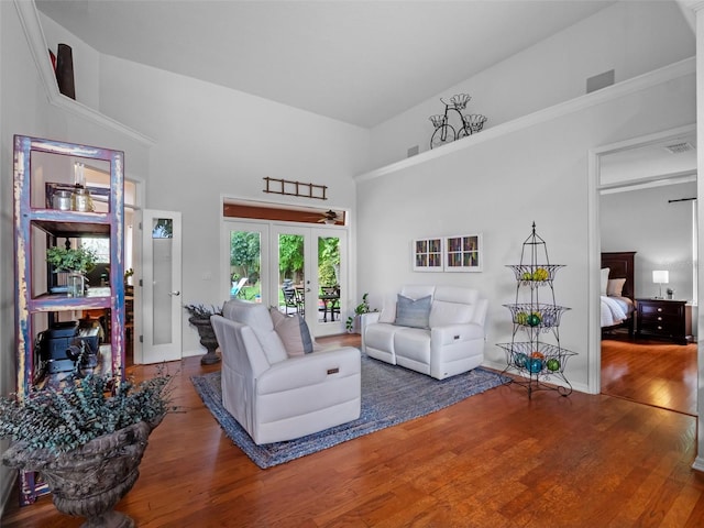 3518 Edlingham Ct, Belle Isle, FL 32812 - living room with wood finished floors, a towering ceiling, french doors, and baseboards