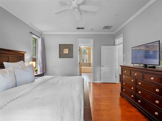 3518 Edlingham Ct, Belle Isle, FL 32812 - bedroom with wood finished floors, crown molding, connected bathroom, a ceiling fan, and baseboards