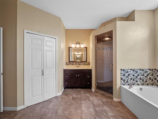 3518 Edlingham Ct, Belle Isle, FL 32812 - full bathroom featuring vanity, a stall shower, a garden tub, and baseboards