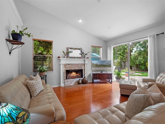3518 Edlingham Ct, Belle Isle, FL 32812 - living area featuring wood finished floors, a stone fireplace, and high vaulted ceiling