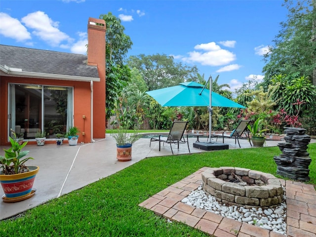 3518 Edlingham Ct, Belle Isle, FL 32812 - view of green lawn with an outdoor fire pit and a patio area