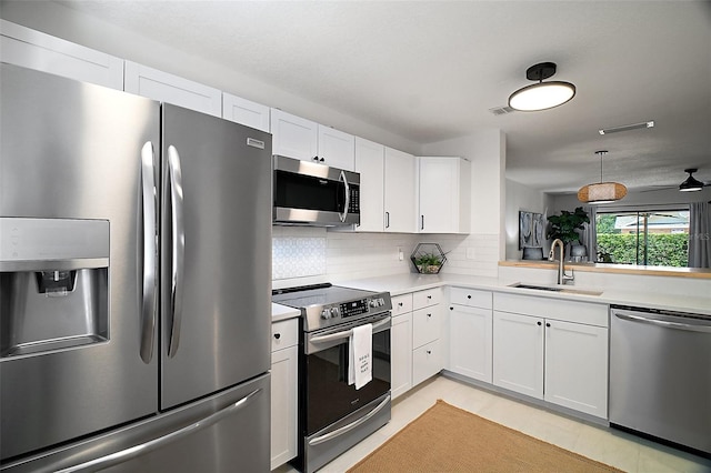 184 Sandlewood Trl Unit 2, Winter Park, FL 32789 - kitchen featuring stainless steel appliances, a sink, light countertops, and white cabinets
