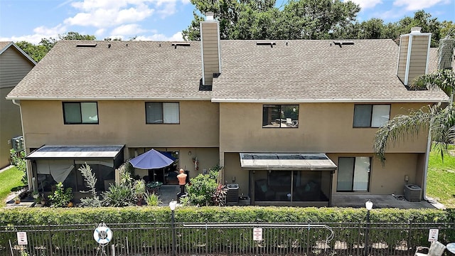 184 Sandlewood Trl Unit 2, Winter Park, FL 32789 - back of house featuring a chimney, stucco siding, and a fenced front yard
