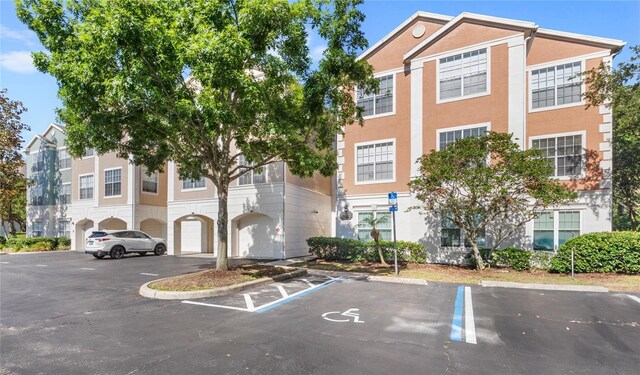 12837 Madison Pointe Cir Unit 206, Orlando, FL 32821 - view of property with uncovered parking