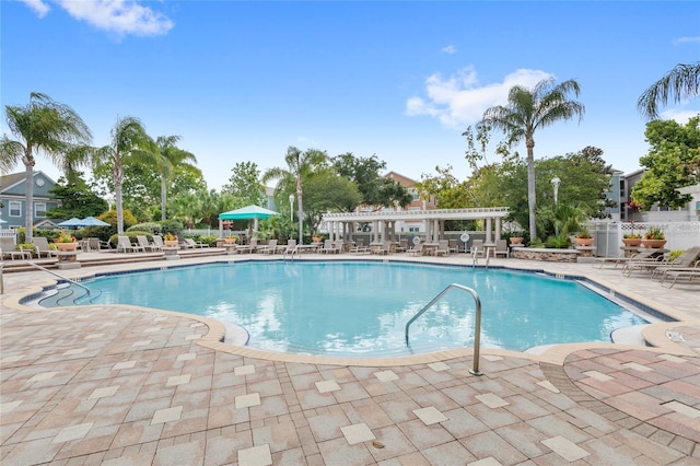 12837 Madison Pointe Cir Unit 206, Orlando, FL 32821 - community pool with a patio area and a pergola