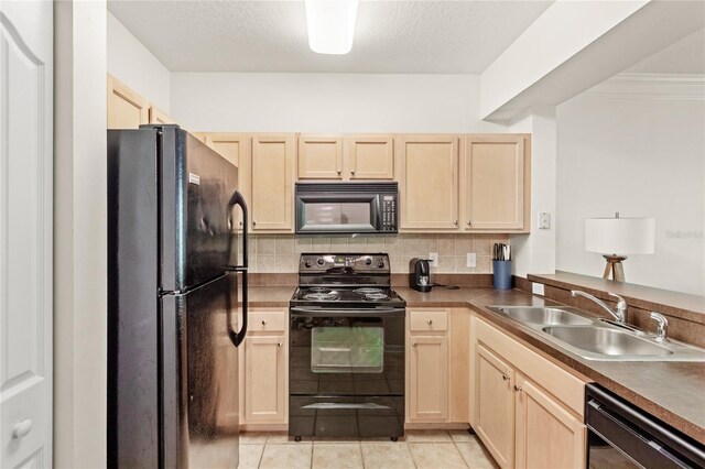 12837 Madison Pointe Cir Unit 206, Orlando, FL 32821 - kitchen featuring black appliances, light brown cabinets, a sink, and decorative backsplash