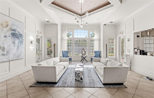 12837 Madison Pointe Cir Unit 206, Orlando, FL 32821 - living room featuring a decorative wall, light tile patterned flooring, ornamental molding, recessed lighting, and a high ceiling
