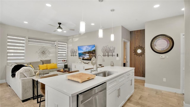 2627 Maitland Crossing Way Unit 101, Orlando, FL 32810 - kitchen with dishwasher, a sink, an island with sink, white cabinets, and recessed lighting