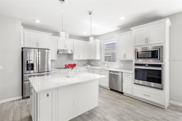 5641 Oak Knoll Dr, Saint Cloud, FL 34771 - kitchen with appliances with stainless steel finishes, under cabinet range hood, white cabinets, and recessed lighting