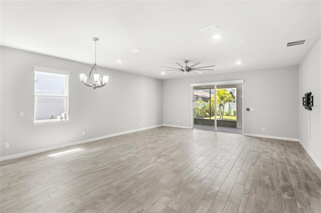 5641 Oak Knoll Dr, Saint Cloud, FL 34771 - unfurnished room with light wood-style flooring, a ceiling fan, a chandelier, recessed lighting, and baseboards