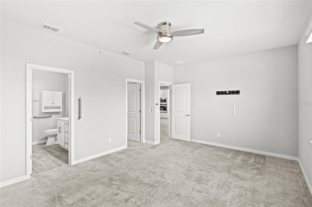 5641 Oak Knoll Dr, Saint Cloud, FL 34771 - unfurnished bedroom featuring carpet flooring, baseboards, connected bathroom, and a ceiling fan