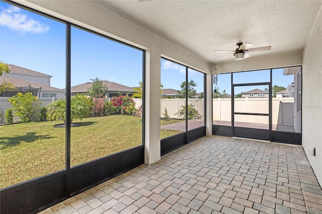 5641 Oak Knoll Dr, Saint Cloud, FL 34771 - unfurnished sunroom with a ceiling fan, a residential view, and plenty of natural light