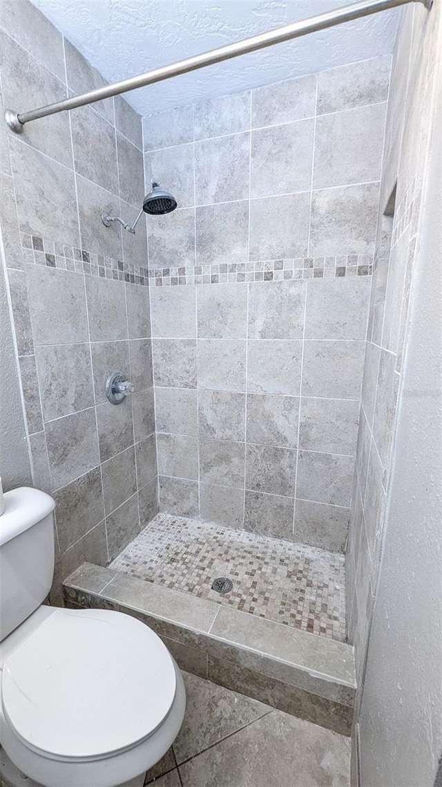 2928 NE 14th Ave, Ocala, FL 34479 - bathroom featuring a shower stall, toilet, and tile patterned floors
