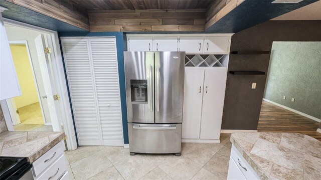 2928 NE 14th Ave, Ocala, FL 34479 - kitchen with stainless steel appliances, wooden ceiling, white cabinetry, baseboards, and tile countertops