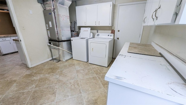 2928 NE 14th Ave, Ocala, FL 34479 - laundry area featuring washing machine and clothes dryer, cabinet space, and baseboards