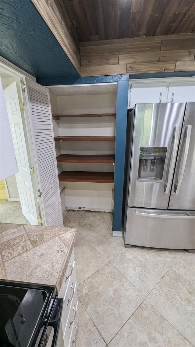 2928 NE 14th Ave, Ocala, FL 34479 - kitchen with stainless steel refrigerator with ice dispenser, electric range oven, white cabinetry, and wooden ceiling