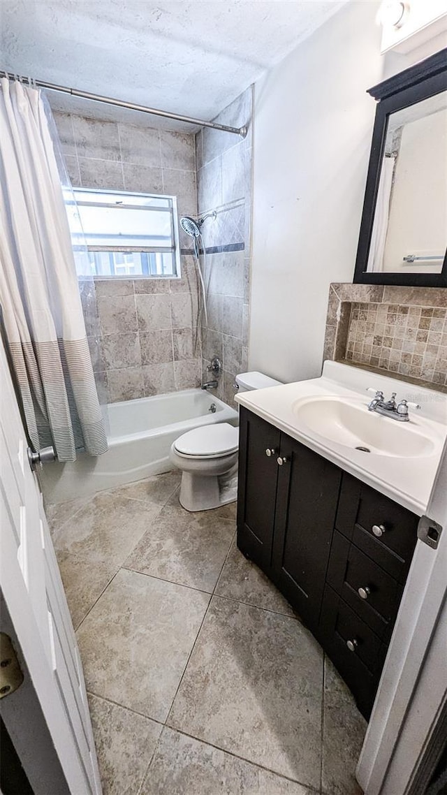 2928 NE 14th Ave, Ocala, FL 34479 - bathroom featuring shower / bath combination with curtain, vanity, toilet, backsplash, and tile patterned floors