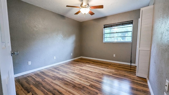 2928 NE 14th Ave, Ocala, FL 34479 - unfurnished room with a textured wall, wood finished floors, a ceiling fan, and baseboards