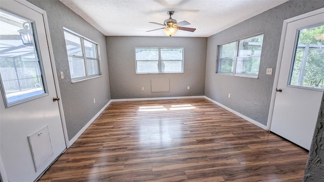 2928 NE 14th Ave, Ocala, FL 34479 - empty room with a textured wall, dark wood-type flooring, a textured ceiling, ceiling fan, and baseboards