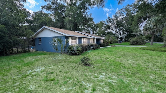 2928 NE 14th Ave, Ocala, FL 34479 - view of side of property featuring a yard and view of wooded area