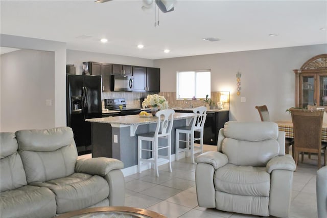 2835 Mosshire Cir, Saint Cloud, FL 34772 - living room featuring light tile patterned floors, a ceiling fan, and recessed lighting