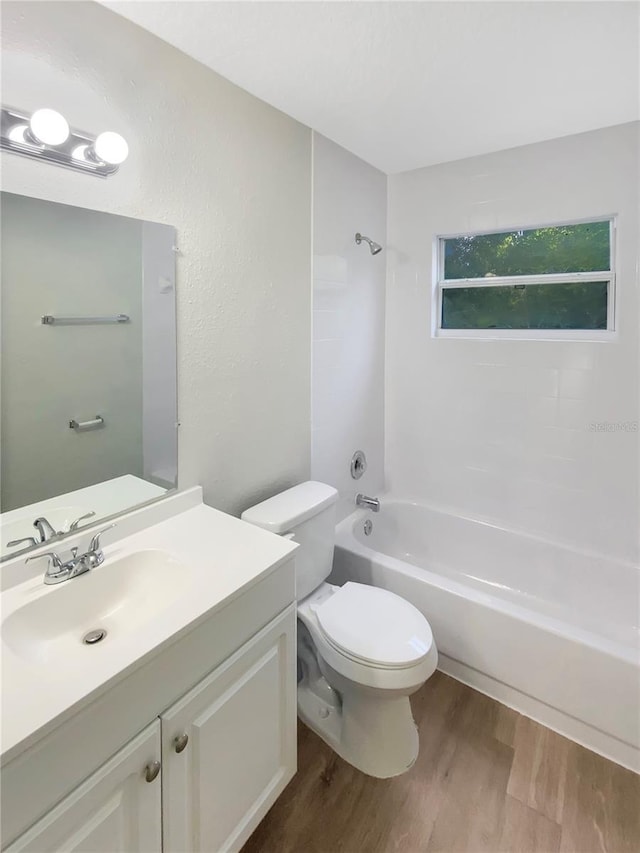 1736 Taylor Lake Pl, Largo, FL 33778 - full bathroom with wood finished floors, vanity, shower / washtub combination, and toilet