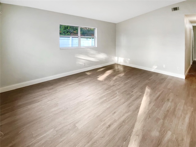 1736 Taylor Lake Pl, Largo, FL 33778 - spare room featuring baseboards and wood finished floors