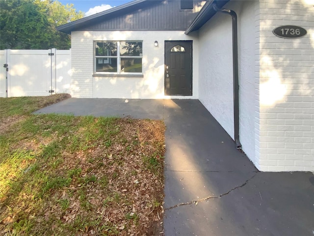1736 Taylor Lake Pl, Largo, FL 33778 - doorway to property with brick siding and stucco siding
