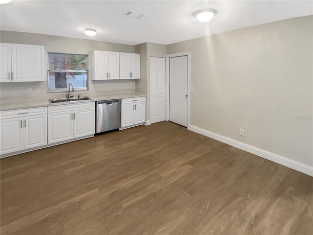 1736 Taylor Lake Pl, Largo, FL 33778 - kitchen with stainless steel dishwasher, a sink, light countertops, baseboards, and white cabinetry