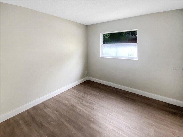 1736 Taylor Lake Pl, Largo, FL 33778 - spare room featuring baseboards and wood finished floors