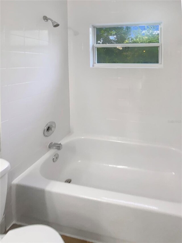 1736 Taylor Lake Pl, Largo, FL 33778 - full bathroom featuring toilet, plenty of natural light, and washtub / shower combination