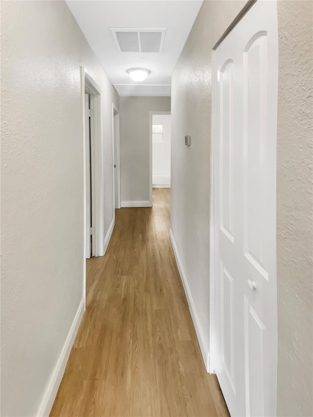1736 Taylor Lake Pl, Largo, FL 33778 - hall featuring wood finished floors, baseboards, a textured wall, and attic access