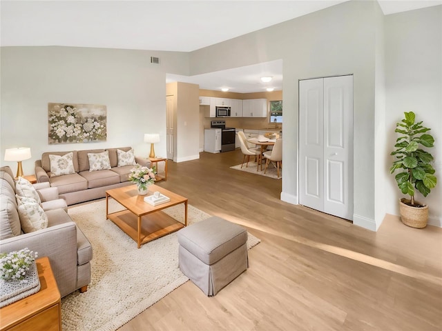 1736 Taylor Lake Pl, Largo, FL 33778 - living room featuring light wood-style floors and baseboards