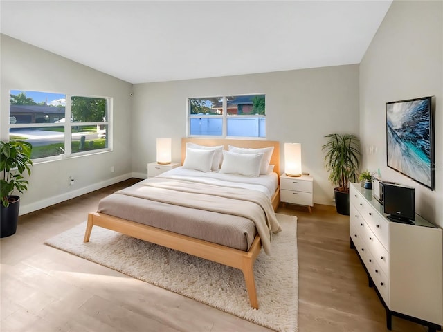 1736 Taylor Lake Pl, Largo, FL 33778 - bedroom featuring lofted ceiling, light wood-type flooring, and baseboards