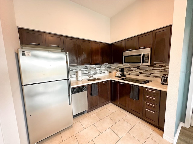 225 Celebration Pl Unit 527, Kissimmee, FL 34747 - kitchen with appliances with stainless steel finishes, a sink, dark brown cabinetry, light countertops, and tasteful backsplash