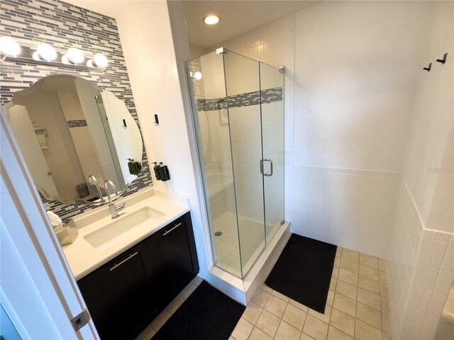 225 Celebration Pl Unit 527, Kissimmee, FL 34747 - bathroom featuring tile walls, tile patterned floors, vanity, a stall shower, and recessed lighting