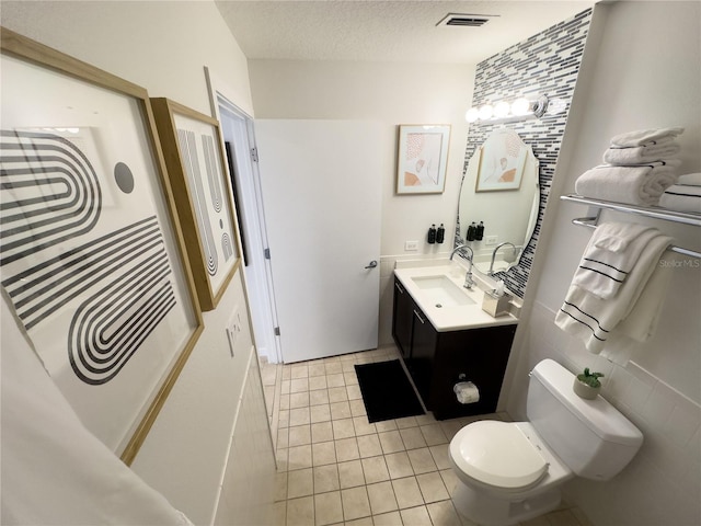 225 Celebration Pl Unit 527, Kissimmee, FL 34747 - bathroom featuring vanity, toilet, a textured ceiling, and tile patterned flooring