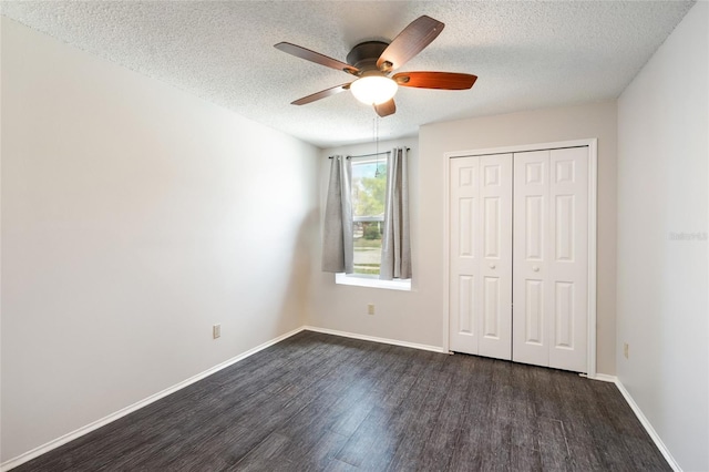 2903 Willow Oak Ct, Kissimmee, FL 34744 - unfurnished bedroom with dark wood-style flooring, a textured ceiling, a closet, baseboards, and a ceiling fan