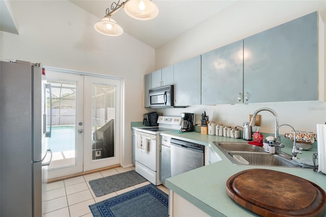 2903 Willow Oak Ct, Kissimmee, FL 34744 - kitchen with stainless steel appliances, french doors, a sink, light tile patterned floors, and light countertops