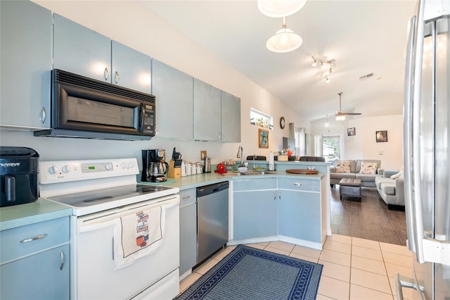 2903 Willow Oak Ct, Kissimmee, FL 34744 - kitchen featuring electric stove, black microwave, stainless steel dishwasher, vaulted ceiling, and open floor plan