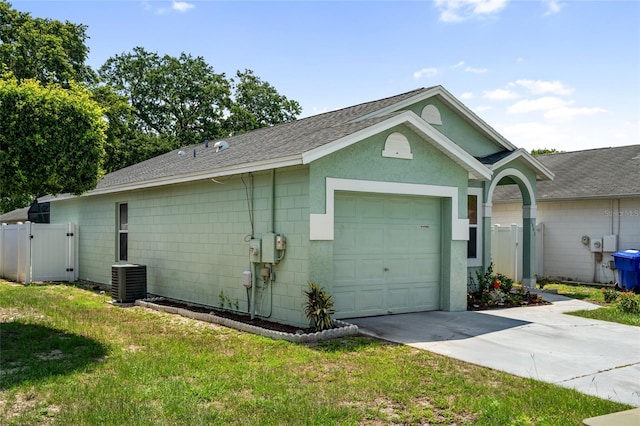 2903 Willow Oak Ct, Kissimmee, FL 34744 - view of side of home featuring a gate, driveway, a shingled roof, central air condition unit, and a garage
