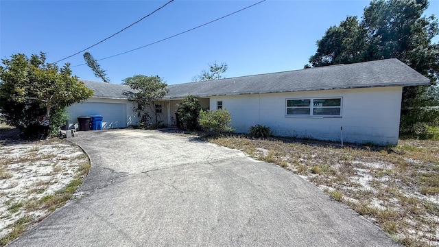 4719 Alcazar Way S, Saint Petersburg, FL 33712 - ranch-style home with driveway, a garage, concrete block siding, and roof with shingles