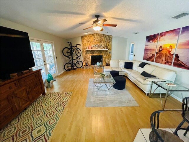 3565 E Lake Dr, Land O Lakes, FL 34639 - living area with a ceiling fan, wood finished floors, baseboards, a fireplace, and vaulted ceiling