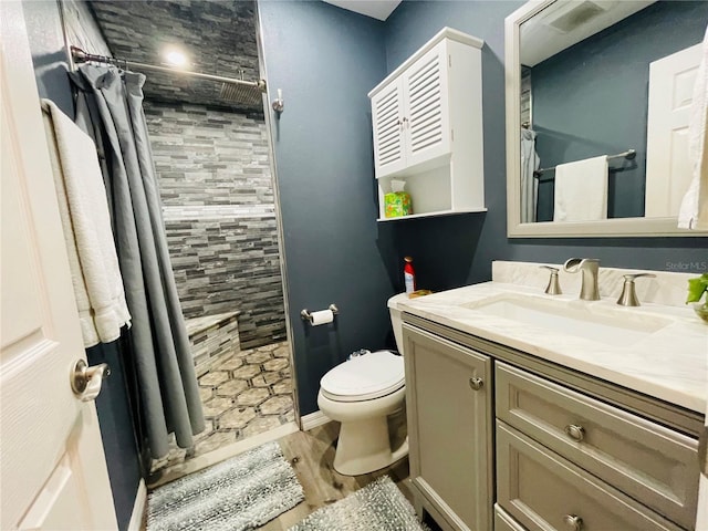 3565 E Lake Dr, Land O Lakes, FL 34639 - full bathroom featuring tiled shower, vanity, toilet, and wood finished floors