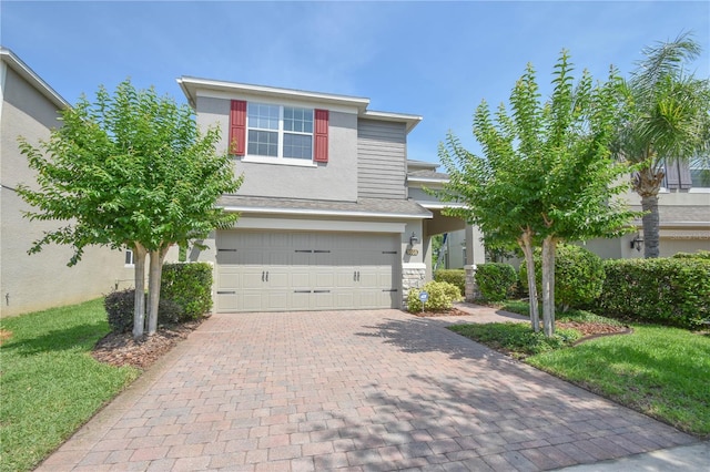 5908 Paxton Ct, Apopka, FL 32703 - view of front of property featuring a garage, decorative driveway, stucco siding, and a front lawn