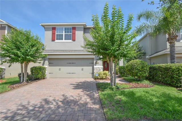 5908 Paxton Ct, Apopka, FL 32703 - view of front of home featuring a garage, decorative driveway, stucco siding, and stone siding